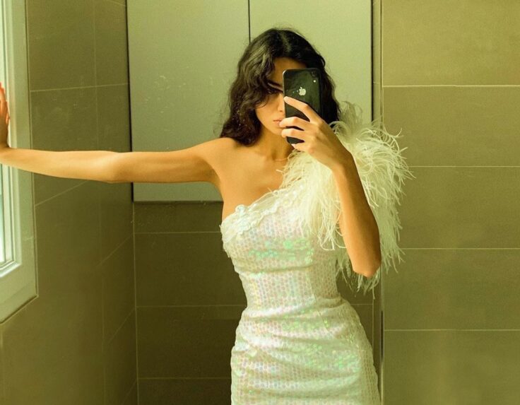 Maya Chantout taking a selfie in a white sequin dress