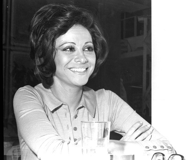 Faten Hamama smiling with her arms crossed