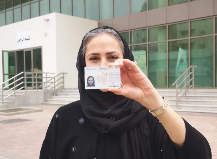 Khaliji woman holding her diver's license