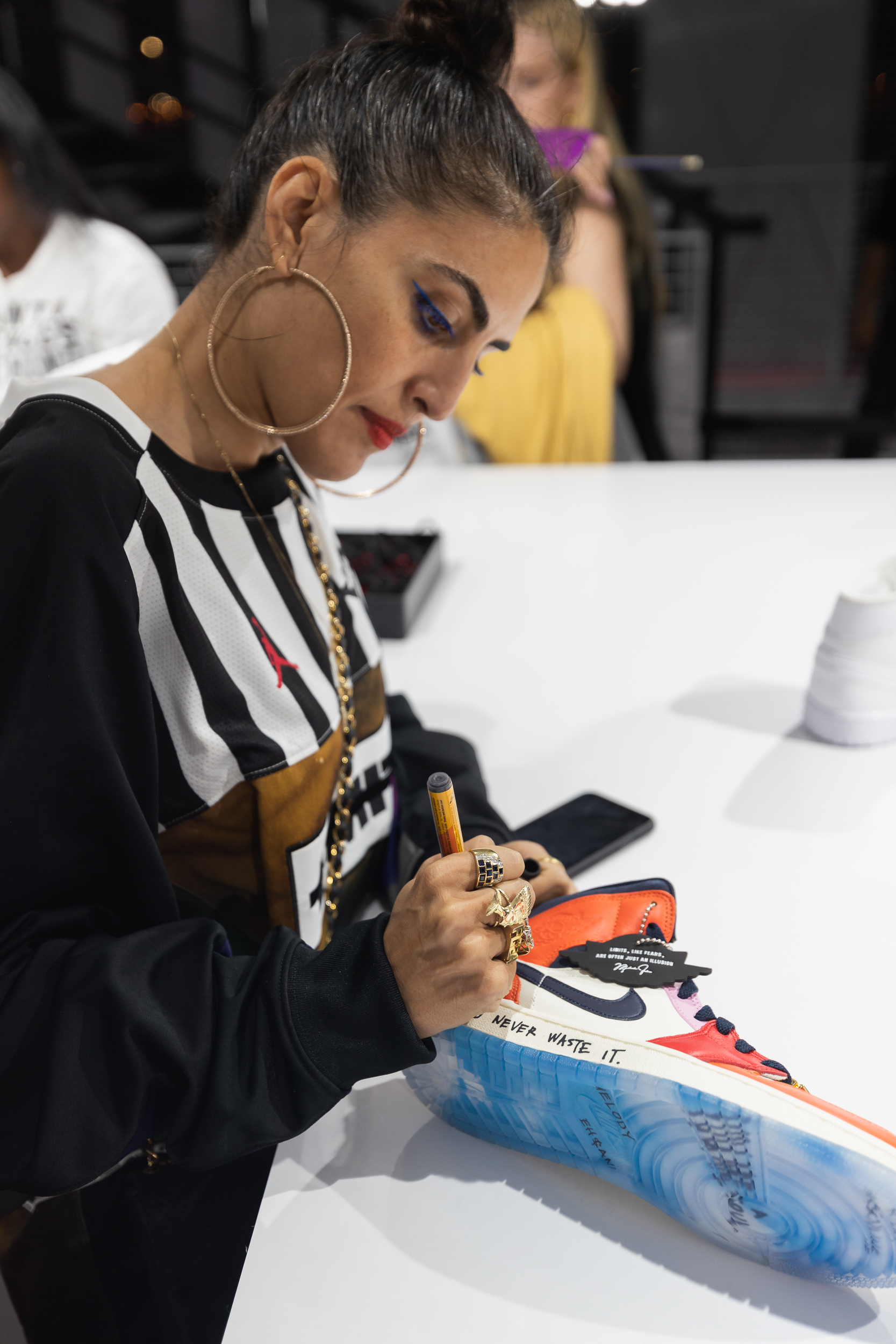 Melody Ehsani personalising a Jordan sneaker