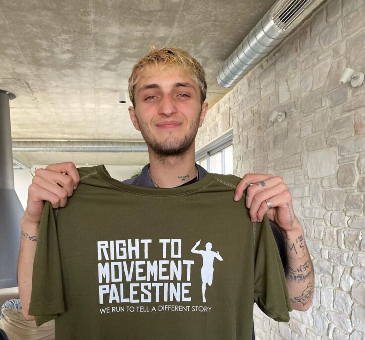 Anwar Hadid holding a "right to movement palestine" t-shirt