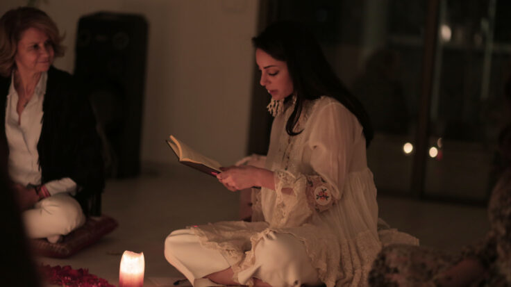 A young woman reading during a healing circle
