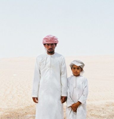 A dad and his son wearing traditional gulf clothes