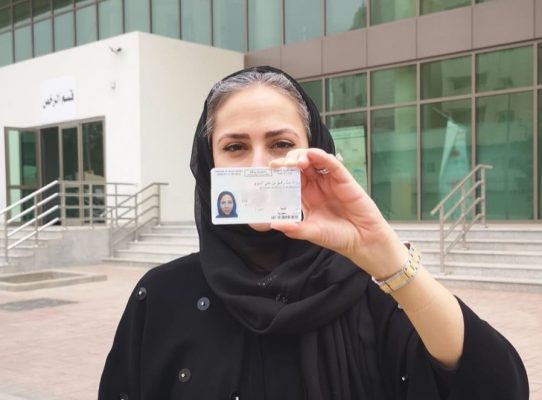 Khaliji woman holding her diver's license