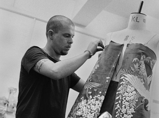 Alexander McQueen working on a gown