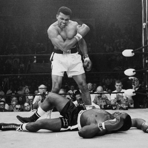 Heavyweight champion Muhammad Ali stands over fallen challenger Sonny Liston, shouting and gesturing shortly after dropping Liston with a short hard right to the jaw on May 25, 1965, in Lewiston, Maine.  The bout lasted only one minute into the first round.  Ali is the only man ever to win the world heavyweight boxing championship three times.  He also won a gold medal in the light-heavyweight division at the 1960 Summer Olympic Games in Rome as a member of the U.S. Olympic boxing team.  In 1964 he dropped the name Cassius Clay and adopted the Muslim name Muhammad Ali.  (AP Photo/John Rooney)