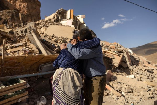 TOPSHOT - Family members react near the rubble of collapsed buildings in the village of Imi N'Tala near Amizmiz in central Morocco after the deadly 6.8-magnitude September 8 earthquake, on September 10, 2023. Using heavy equipment and even their bare hands, rescuers in Morocco on September 10 stepped up efforts to find survivors of a devastating earthquake that killed more than 2,100 people and flattened villages. (Photo by FADEL SENNA / AFP) (Photo by FADEL SENNA/AFP via Getty Images)