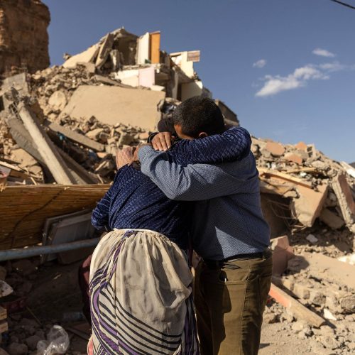 TOPSHOT - Family members react near the rubble of collapsed buildings in the village of Imi N'Tala near Amizmiz in central Morocco after the deadly 6.8-magnitude September 8 earthquake, on September 10, 2023. Using heavy equipment and even their bare hands, rescuers in Morocco on September 10 stepped up efforts to find survivors of a devastating earthquake that killed more than 2,100 people and flattened villages. (Photo by FADEL SENNA / AFP) (Photo by FADEL SENNA/AFP via Getty Images)